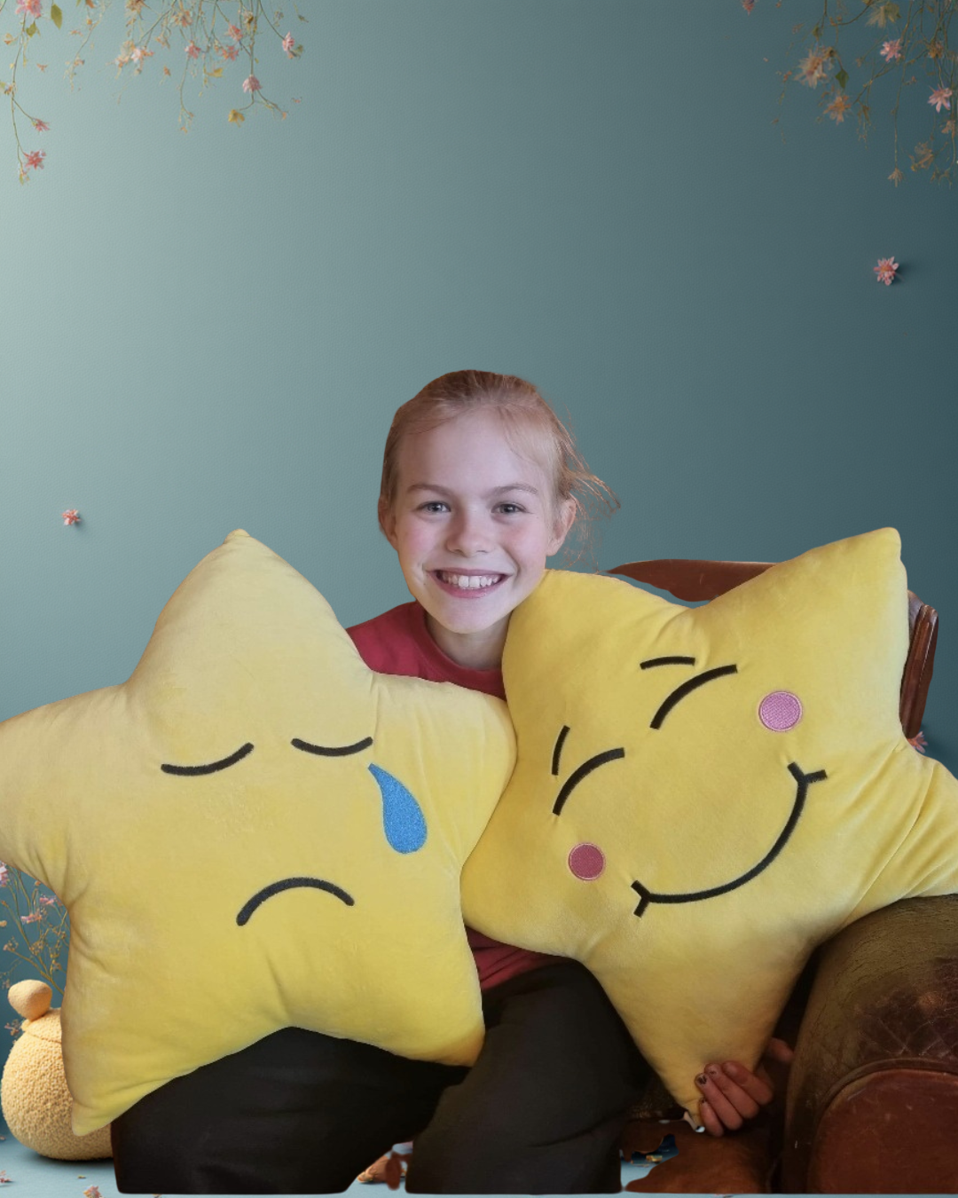 Little girls sits with two yellow star-shaped cushions with happy and sad faces on them